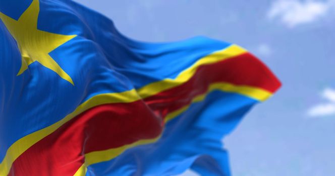 Detail of the national flag of the Democratic Republic of the Congo waving in the wind on a clear day. The DRC is a country in Central Africa. Selective focus.