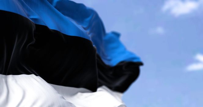 Detail of the national flag of Estonia waving in the wind on a clear day. Estonia is a country in northern Europe. Selective focus.