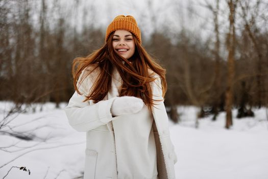 young woman in winter clothes in a hat fun winter landscape Lifestyle. High quality photo