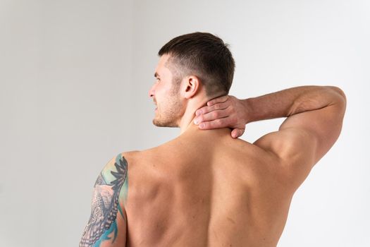 The muscles of the neck in a man on a white background are hurt body cramp white young adult, muscular expression. red therapy, lower suffer attractive