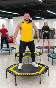 Women's and men's group on a sports trampoline, fitness training, healthy life - a concept trampoline group batut instructor health, from female athletic from training for exercise person, sportive beautiful. Many bodycare athlete, exercising