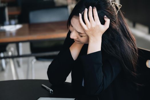 Concept Burnout Syndrome. Business Woman feels uncomfortable working. Which is caused by stress, accumulated from unsuccessful work And less resting body. Consult a specialist psychiatrist