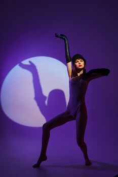 Portrait of a charming lady posing on stage spotlight silhouette disco purple background unaltered. High quality photo
