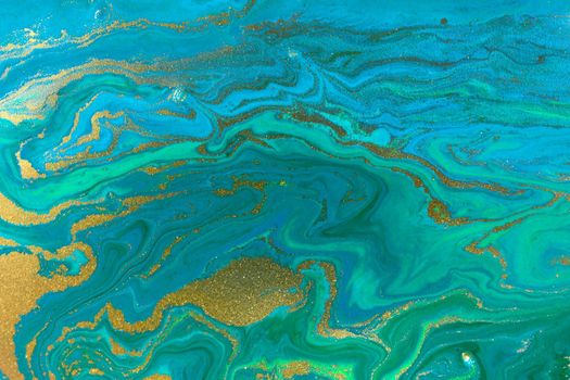 Gold waves on flow blue paints background. Abstract print.