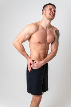 Aching hip in a man white background strong muscle, backache sick isolated massage adult, hand holding. Touching sickness, disease suffer attractive