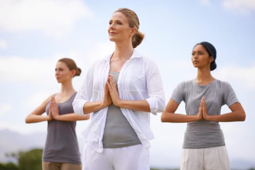 Women doing yoga outdoors.