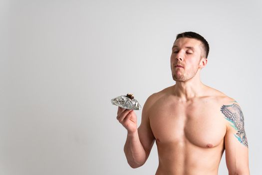 Man eats protein bar on white background isolated protein diet food, nutrition holding smiling person, energetic beautiful granola, attractive female