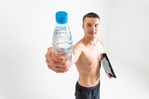 Male drink-water fitness is pumped with a towel on a white background isolated strong workout health, drink young man person, background hydration. active, caucasian one muscle