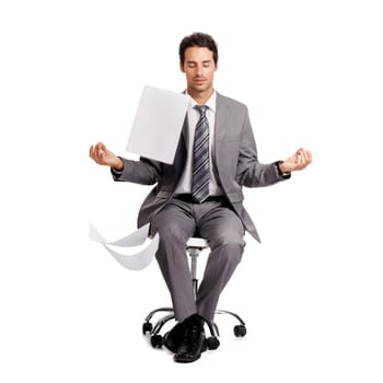 A zen businessman sitting in the lotus position amidst a swarm of paperwork.