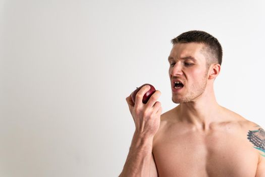 Man holds apples in fitness white background isolated healthy body, muscular fruit lifestyle background, torso studio. Guy hold nutrition, active chest