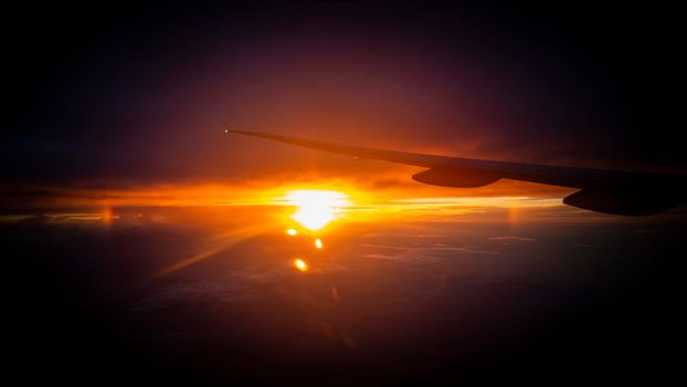 sunrise from the window with intercontinental airplane wing. High quality photo