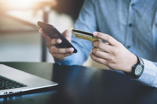 Online Shopping and Internet Payments, Asian man are using their credit card and mobile phone to shop online or conduct errands in the digital world