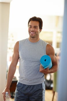 Shot of a handsome young man in sports wear on his way to yoga.