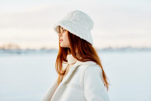 pretty woman red hair snow field winter clothes Lifestyle. High quality photo