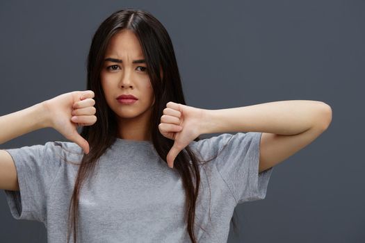 Brunette in a t-shirt and jeans posing Youth style isolated background. High quality photo