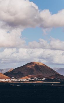 Amazing panoramic landscape of volcano craters in Timanfaya national park. Popular touristic attraction in Lanzarote island, Canary islans, Spain. Artistic picture. Beauty world. Travel concept