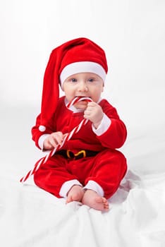 Studio shot of a little boy dressed up in a santa costume.