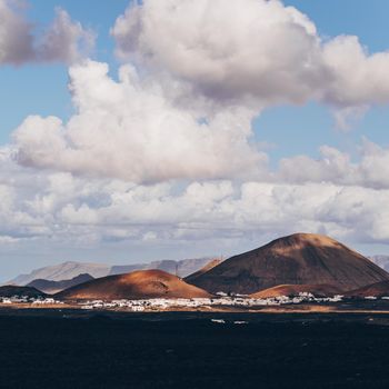 Amazing panoramic landscape of volcano craters in Timanfaya national park. Popular touristic attraction in Lanzarote island, Canary islans, Spain. Artistic picture. Beauty world. Travel concept