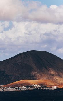 Amazing panoramic landscape of volcano craters in Timanfaya national park. Popular touristic attraction in Lanzarote island, Canary islans, Spain. Artistic picture. Beauty world. Travel concept