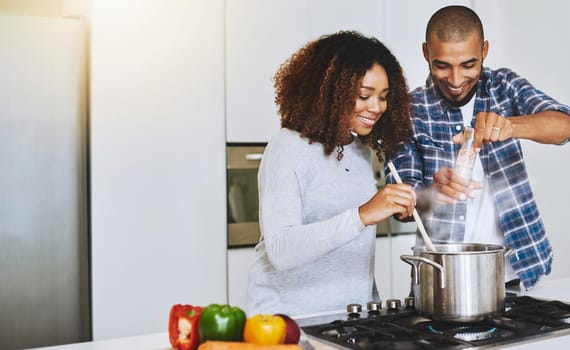 Shot of a young couple cooking together at home.