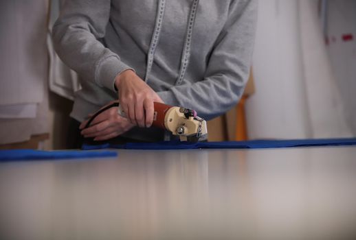 Cutting the cloth by sketching using the instrument. Clothing industry