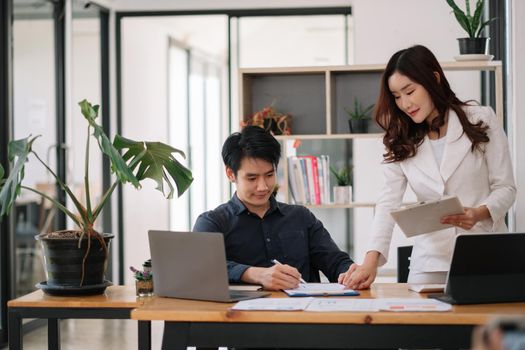 Asian business adviser meeting to analyze and discuss the situation on the financial report in the meeting room.Investment Consultant, Financial advisor and accounting concept