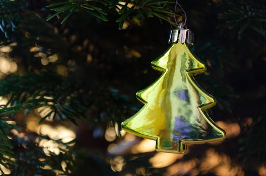 A decoration of the Christmas tree hanging on a fir tree