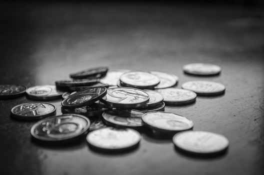 Black and white image of coins, czech crowns currency, shallow depth of field
