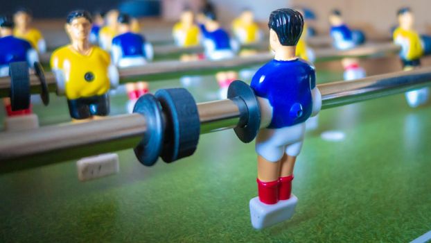 Close up view of a table footbal kicker wearing a blue football dress