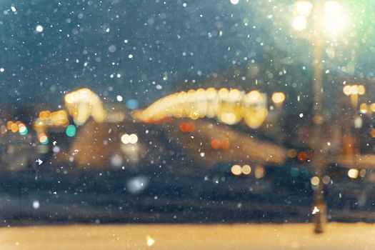 blurred background. road traffic in a big city on a winter night in heavy snow