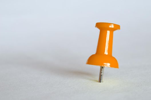 Orange push pin. Closeup photography of orange thumbtack.