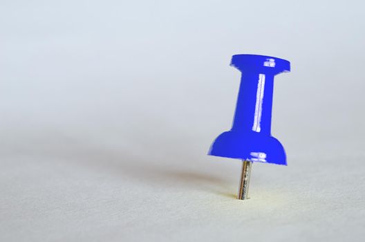 Blue push pin. Closeup photography of blue thumbtack.