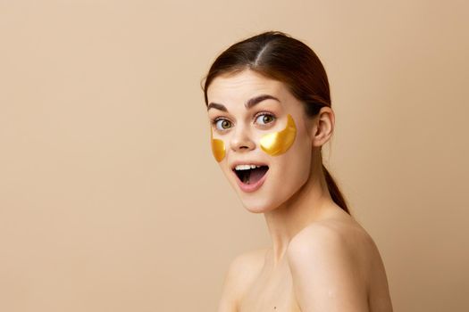 beautiful woman golden patches on the face isolated background. High quality photo