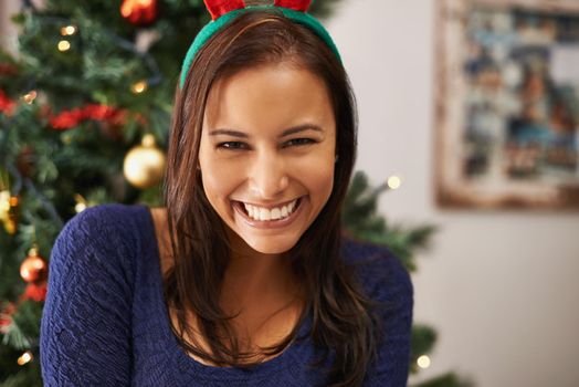 Cropped shot of a gorgeous young woman wearing reindeer antlers.
