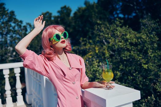 glamorous woman with pink hair summer cocktail refreshing drink Summer day. High quality photo