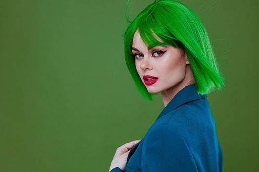 Young woman fun gesture hands green hair fashion studio model unaltered. High quality photo