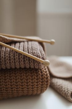 Knitting needles with threads, beige yarn. Hobby for women concept. Knitting accessories.