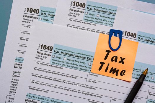 Tax forms 1040. U.S Individual Income Tax Return on a desk with text on notepad . Business and tax concept.