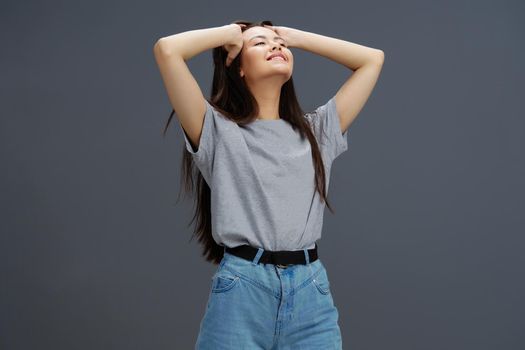 pretty woman in a t-shirt and jeans posing Youth style isolated background. High quality photo