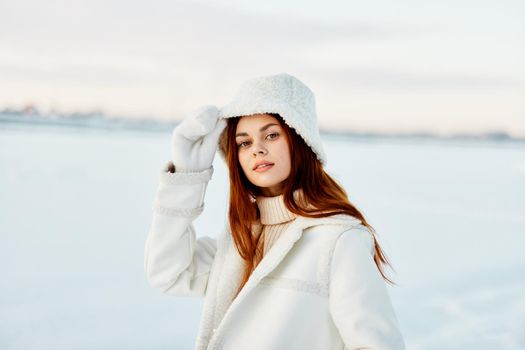 woman red hair snow field winter clothes Lifestyle. High quality photo