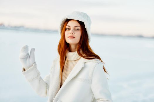 pretty woman red hair snow field winter clothes Lifestyle. High quality photo