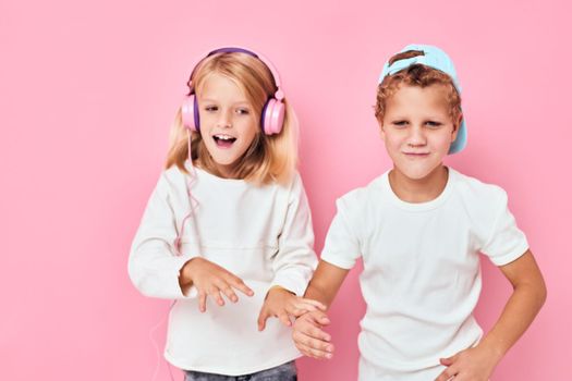 a boy in a cap and a girl standing side by side posing fashion lifestyle childhood. High quality photo