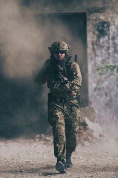 A bearded soldier in the uniform of special forces in dangerous military action in a dangerous enemy area. Selective focus. High-quality photo