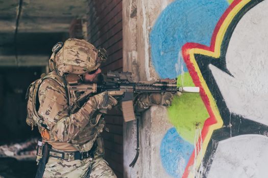 A bearded soldier in the uniform of special forces in dangerous military action in a dangerous enemy area. Selective focus. High-quality photo