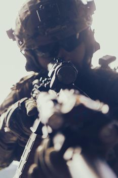 Close-up photo of a bearded soldier in the uniform of special forces in dangerous military action in a dangerous enemy area. Selective focus. High-quality photo