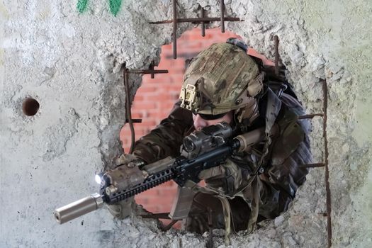 A bearded soldier in the uniform of special forces in dangerous military action in a dangerous enemy area. Selective focus. High-quality photo