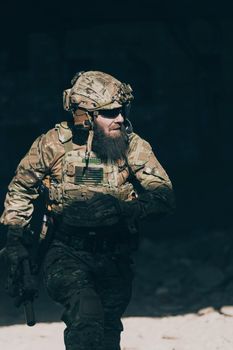 A bearded soldier in the uniform of special forces in dangerous military action in a dangerous enemy area. Selective focus. High-quality photo