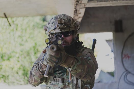 A bearded soldier in the uniform of special forces in dangerous military action in a dangerous enemy area. Selective focus. High-quality photo