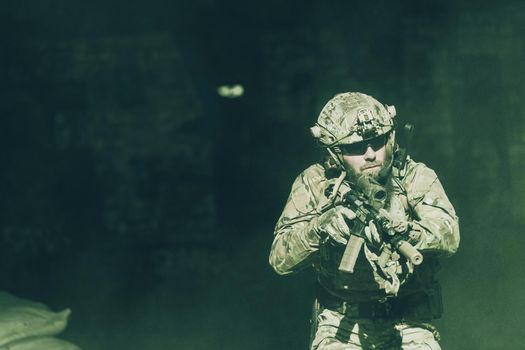 A bearded soldier in the uniform of special forces in dangerous military action in a dangerous enemy area. Selective focus. High-quality photo