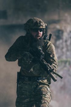 A bearded soldier in the uniform of special forces in dangerous military action in a dangerous enemy area. Selective focus. High-quality photo